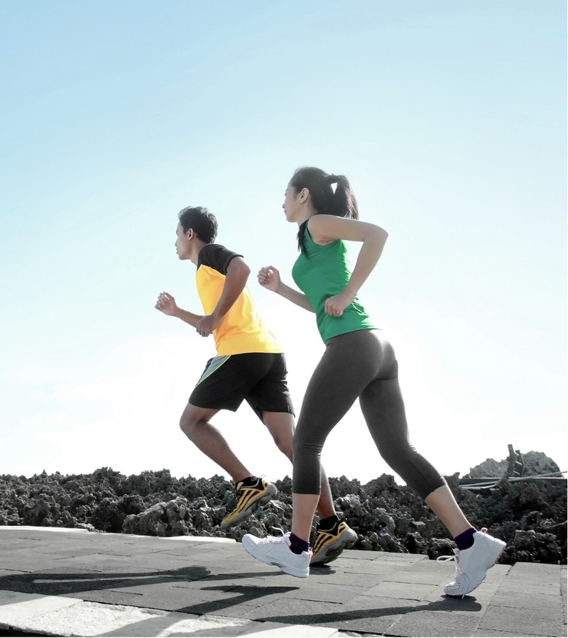 Two people running on a road with a clear blue sky using Zeta-FX Supplements